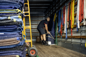 Furniture removalists Frankston team securing furniture with straps inside a moving truck